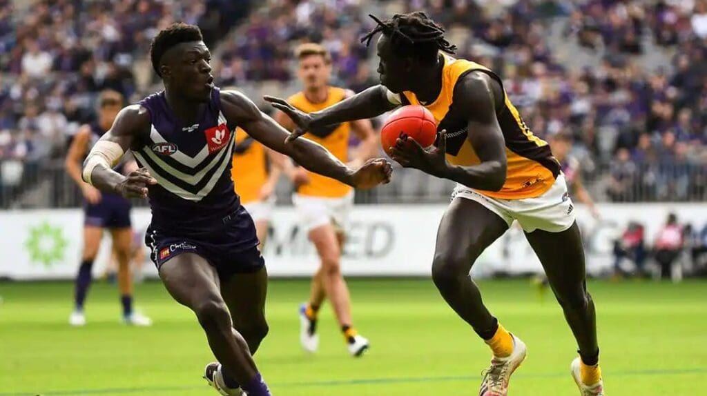 CJ fends of Fremantle's Michael Fredrick - Getty Images