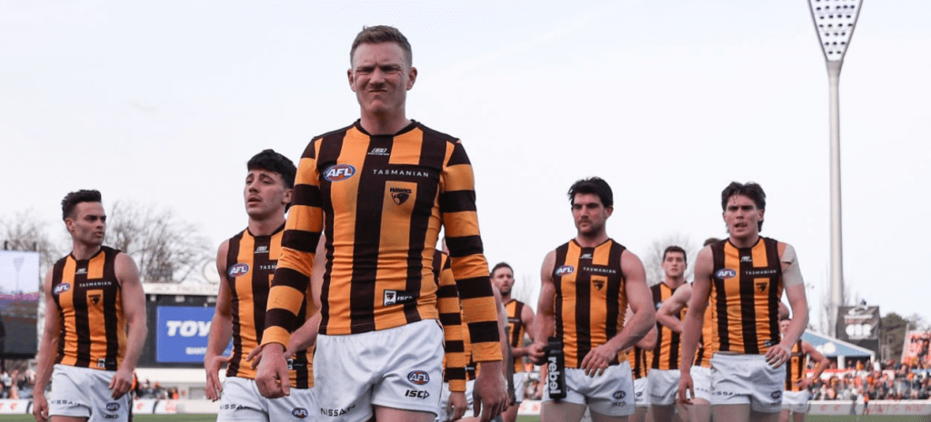 A dejected James Sicily leads the Hawks off the field. Photo by Brendon Thorne via Getty Images.